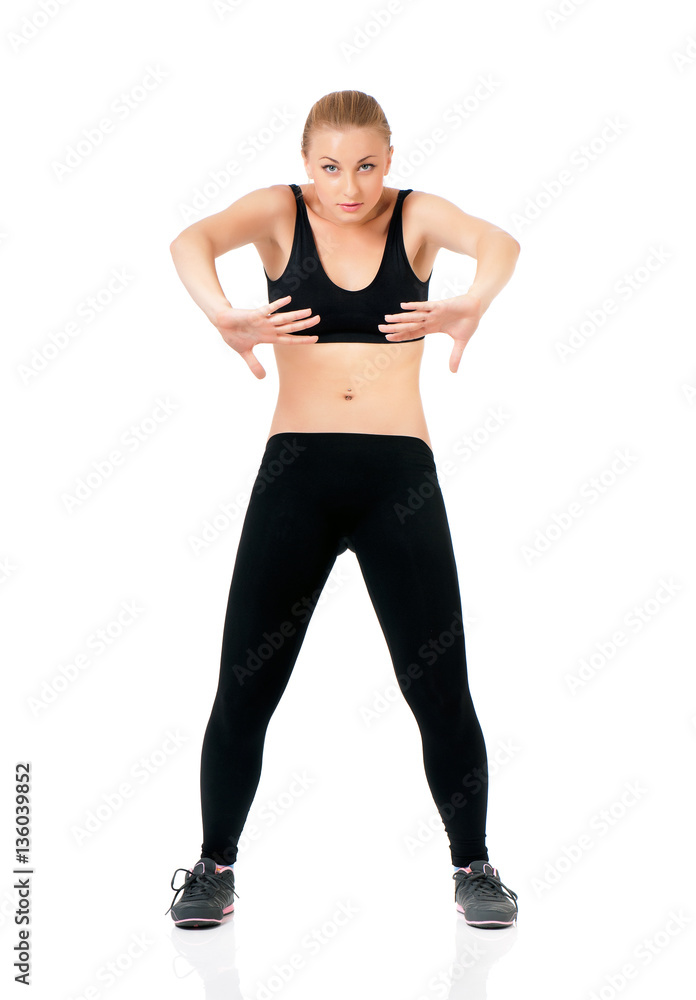 Beautiful fitness woman posing in studio - showing how to keep fit doing warming up exercises. Young sportswoman, isolated on white background. Beautiful fitness woman posing in studio - showing how to keep fit doing warming up exercises. Young sportswoman, isolated on white background.