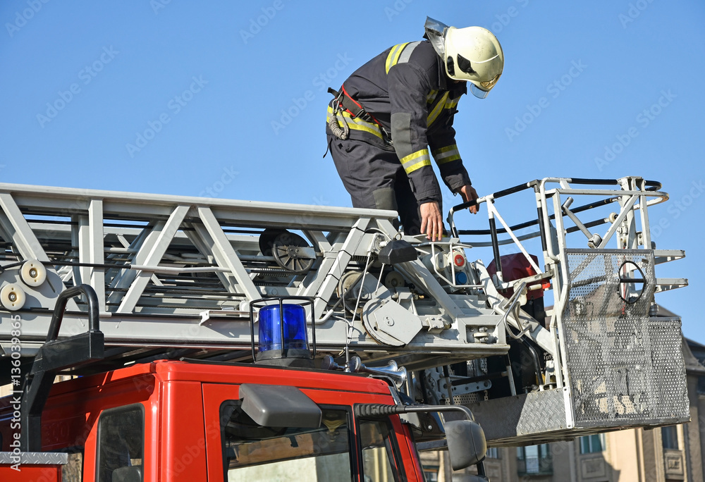 Firefighter on the top of a fire truck