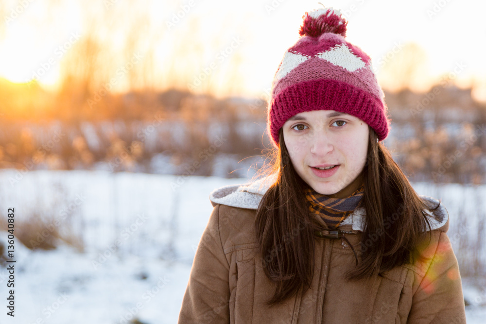 Teenage girl enjoys bright sunset lights in winter Teenage girl enjoys bright sunset lights in winter