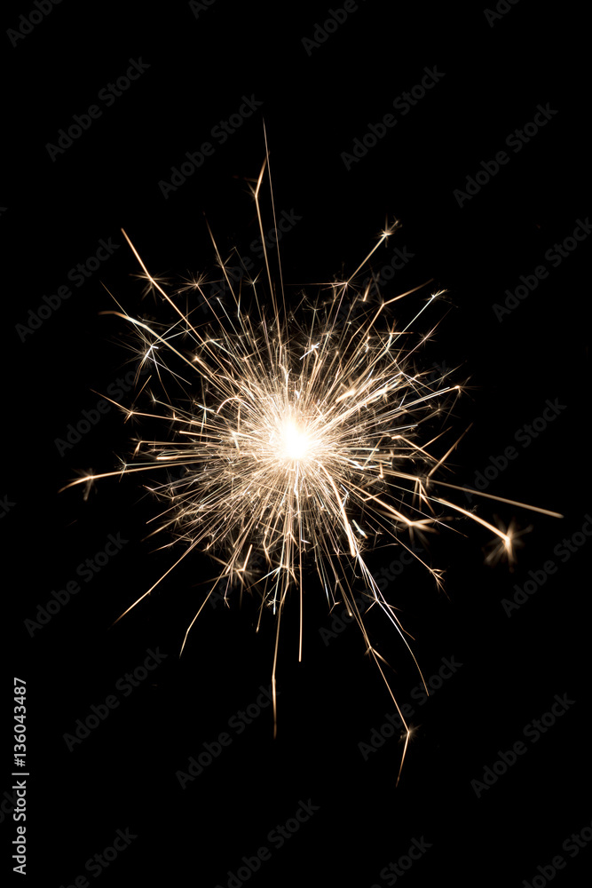 A burning sparkler on a black background A burning sparkler on a black background