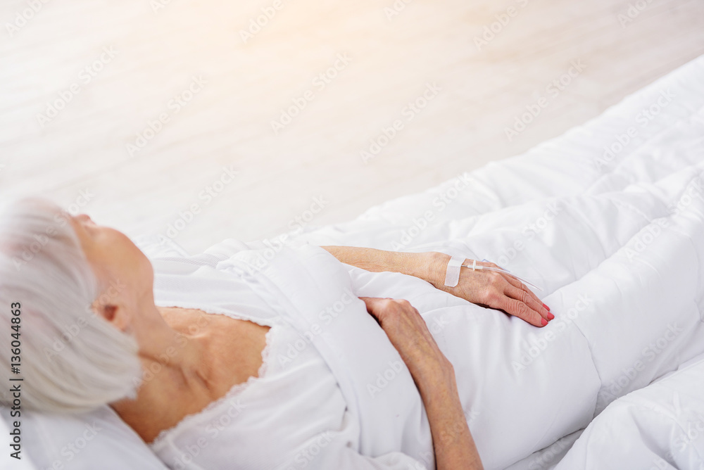 Retiree is on drop glass reclining in bed Retiree is on drop glass reclining in bed