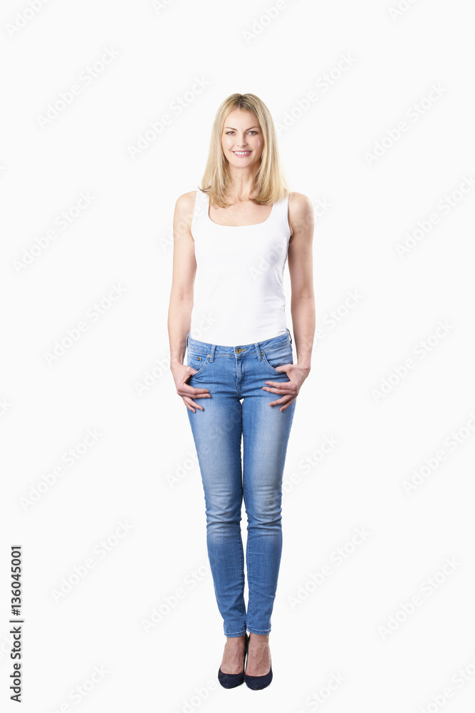 Female portrait. Full length shot of a confident mature woman standing against at white background. Female portrait. Full length shot of a confident mature woman standing against at white background.