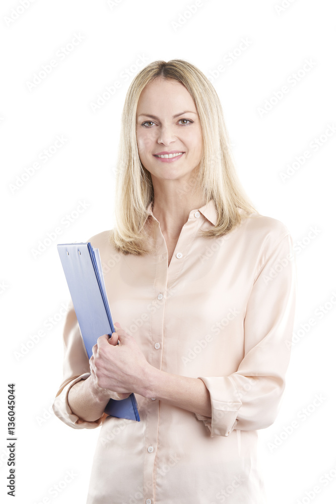 Businesswoman at isolated background. Shot of a smiling middle aged woman holding clipboard in her hands while standing against white background. Businesswoman at isolated background. Shot of a smiling middle aged woman holding clipboard in her hands while standing against white background.