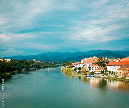 Maribor Old Town View and Drava River on Mountains Background. Popular Touristic Destination in Slovenia, Europe. Beautiful Slovenian Landscape. Copy Space.