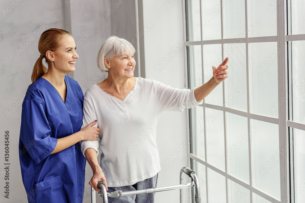 Outgoing grandmother demonstrating physician what is going on