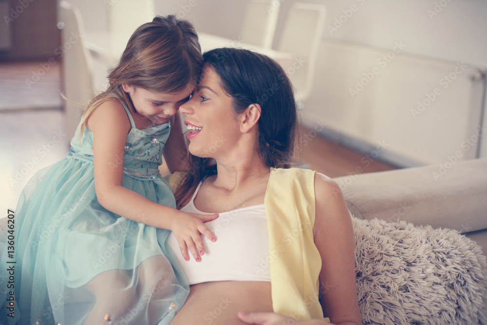 Pregnant woman and her little daughter. Pregnant woman and her little daughter.
