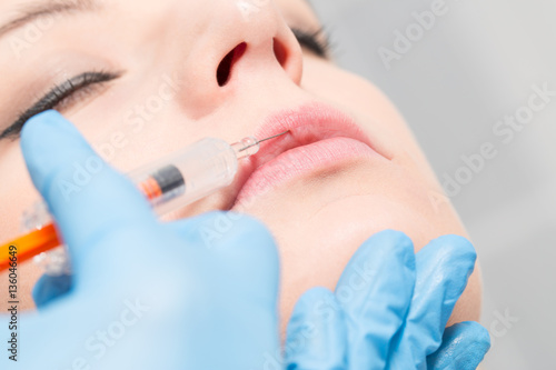 Close-up cosmetic fillers treatment with syringe injection