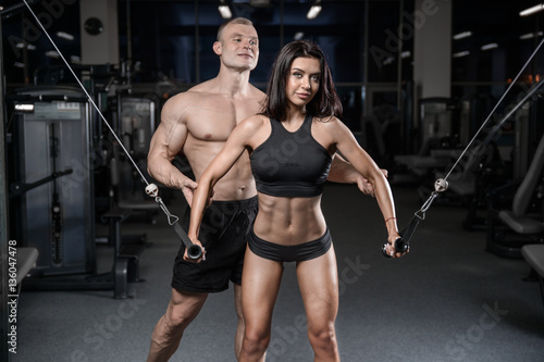 sexy caucasian man and woman in gym .