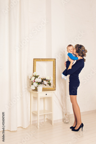 Mother and her child, embracing with tenderness and care, child giving mother flowers. Mother day concept, happiness and love