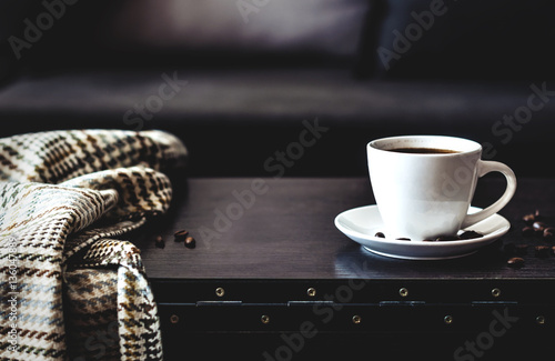 one white cups of morning coffee on the table photo