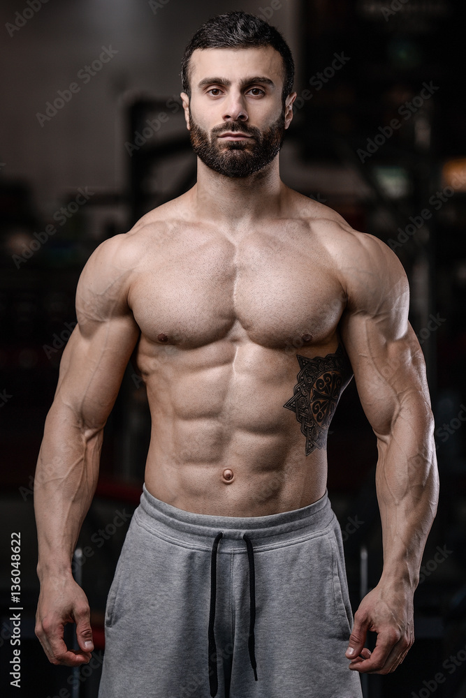 Fototapeta premium Handsome fitness model train in the gym gain muscle.