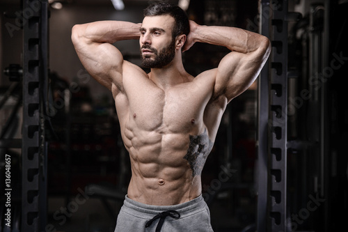 Handsome fitness model train in the gym gain muscle.