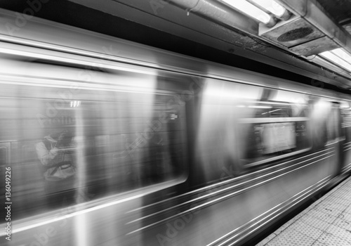 New York subway train fast moving in station photo