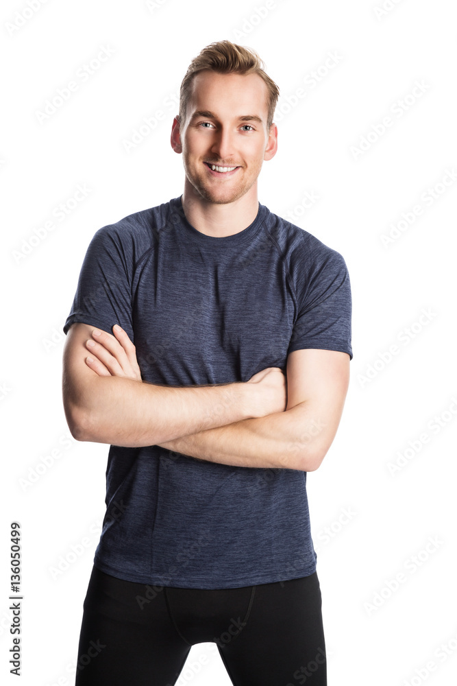 Blonde man wearing workout clothing standing against a white background staring at camera. Blonde man wearing workout clothing standing against a white background staring at camera.