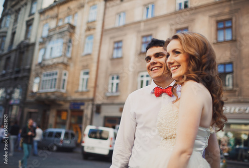 The lovely couple in love embracing in the center of town