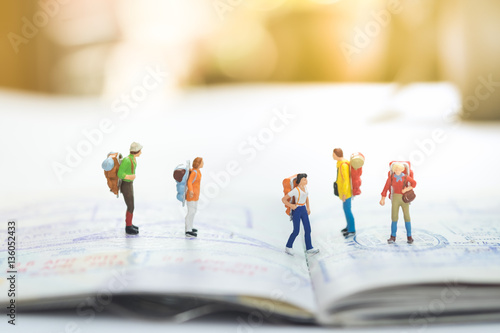 Miniature people with travelling concepts. Group of backpackers