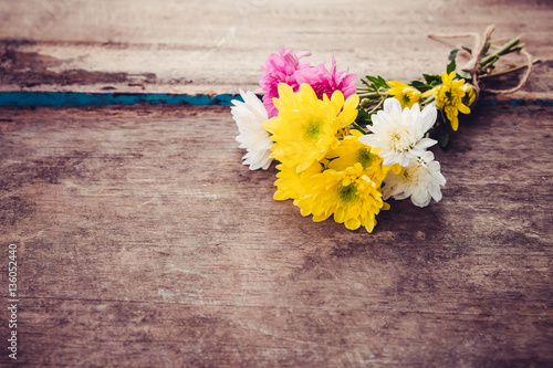 bouquet flowers in spring on vintage wooden background. vintage color tone.