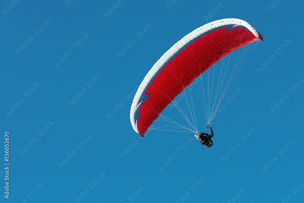 Paraglider flying in a beautiful blue sky Paraglider flying in a beautiful blue sky