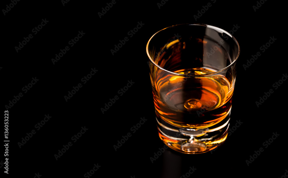 Glass of whiskey isolated on black background Glass of whiskey isolated on black background