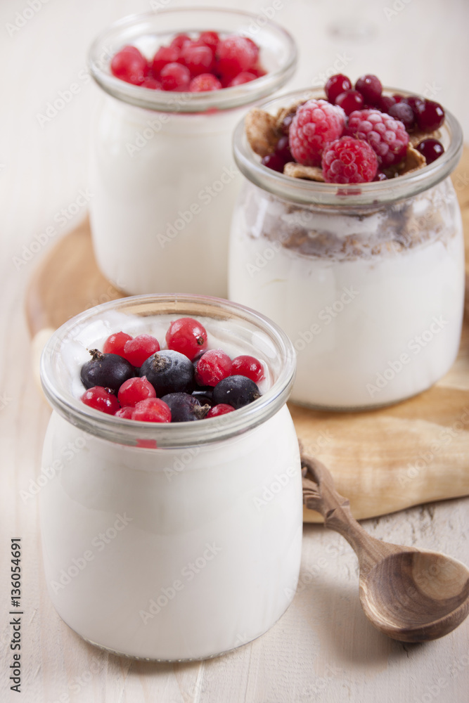 Homemade yogurt with berries in three banks Homemade yogurt with berries in three banks