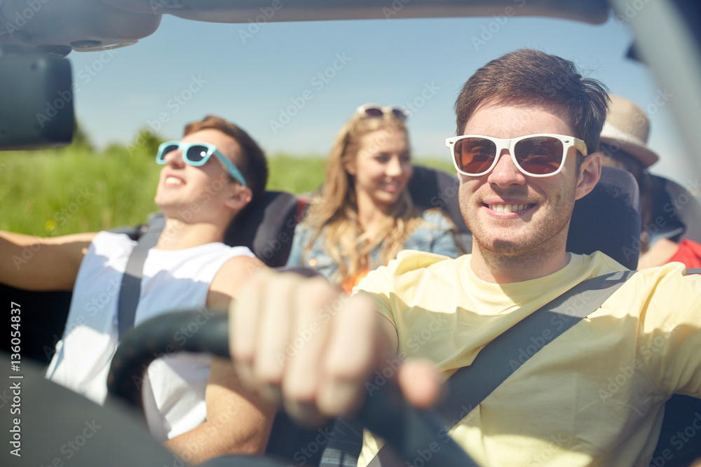 happy friends driving in cabriolet car happy friends driving in cabriolet car