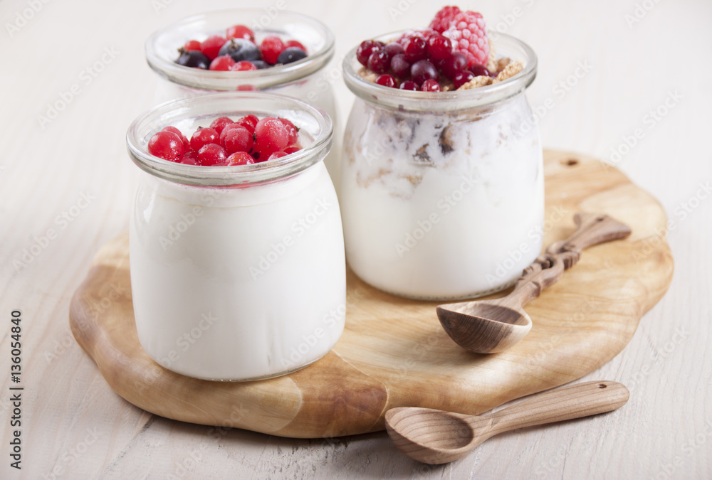 Homemade yogurt with berries in three banks Homemade yogurt with berries in three banks