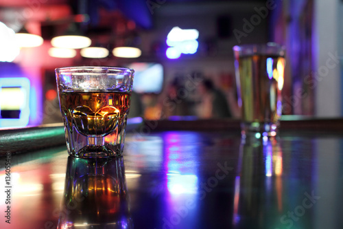 Shot of whiskey and a beer at a dive bar.
