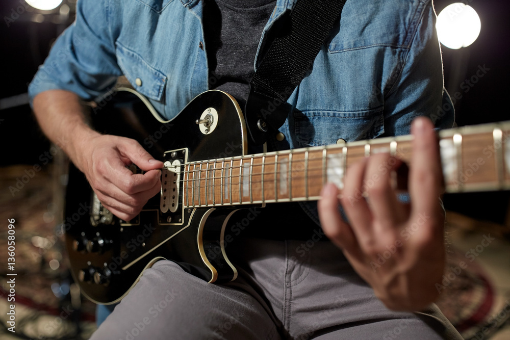 man playing guitar at studio rehearsal