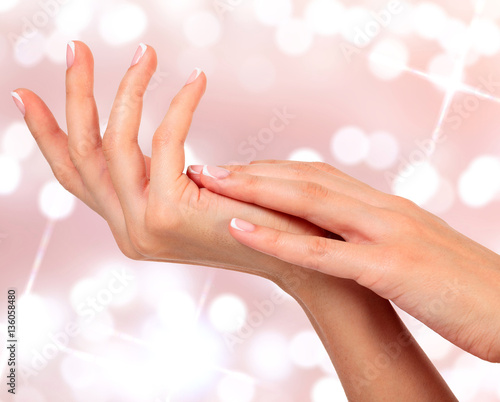 Beautiful woman hands against an abstract background