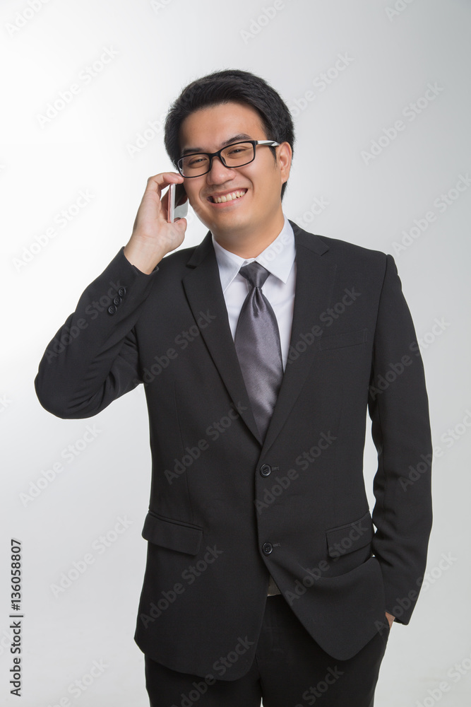 Young asian handsome businessman and glasses using smartphone Young asian handsome businessman and glasses using smartphone