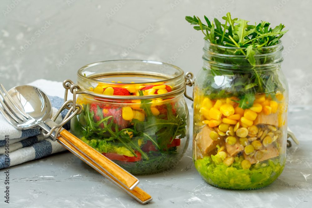 Healthy take-away lunch jars. Guacamole, corn, tofu, beans, arugula. Paprika, falafel, dill and corn. Clean eating, vegetarian, raw, detox, dieting concept Healthy take-away lunch jars. Guacamole, corn, tofu, beans, arugula. Paprika, falafel, dill and corn. Clean eating, vegetarian, raw, detox, dieting concept