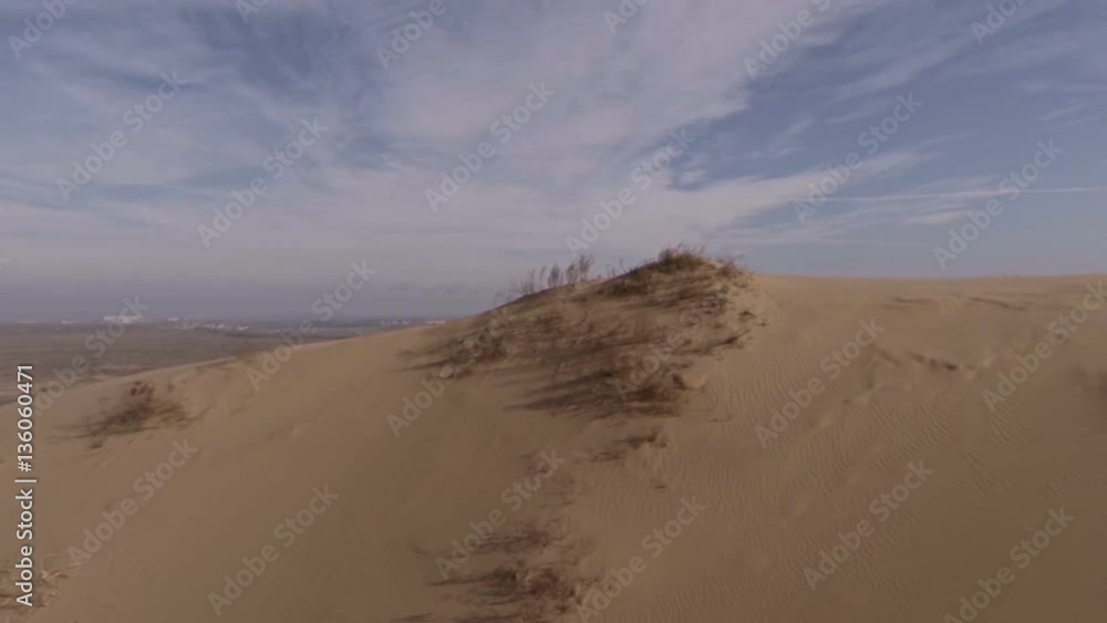The unique sandy barkhan SariKum in Russia. Aerial view. The unique sandy barkhan SariKum in Russia. Aerial view.
