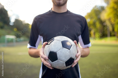 close up of soccer player with football on field © Syda Productions
