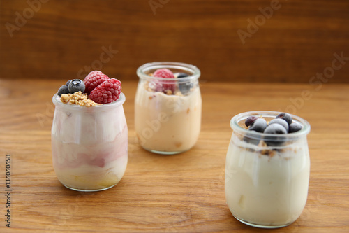 Yogurt and cream dessert with berries, cereals, muesli and zwieback. Measure tape. healthy food. fitness concept. on an old wooden table