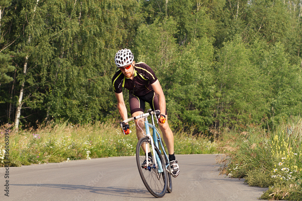Fototapeta premium cyclist trains, young man in a sports bike. 
