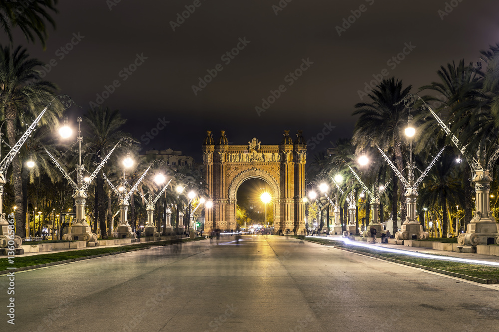 The view on Arc de Triomf from the park in evening, Barcelona, Spain. A lot of lights and perspective lines.