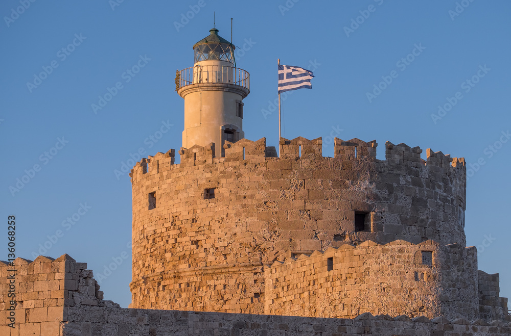Sunset at the lighthouse and castle on Rhodes, Greece