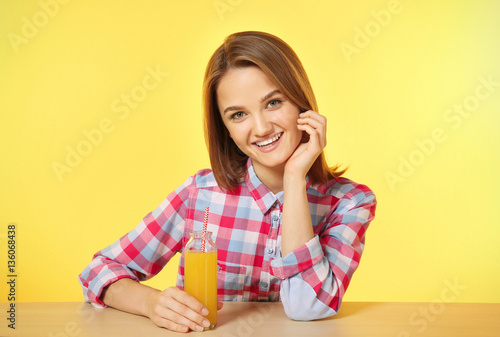Young woman sitting at the ...