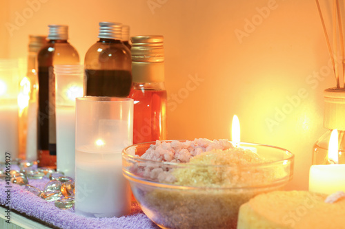 Bottles of essential oil  sea salt and candles on table