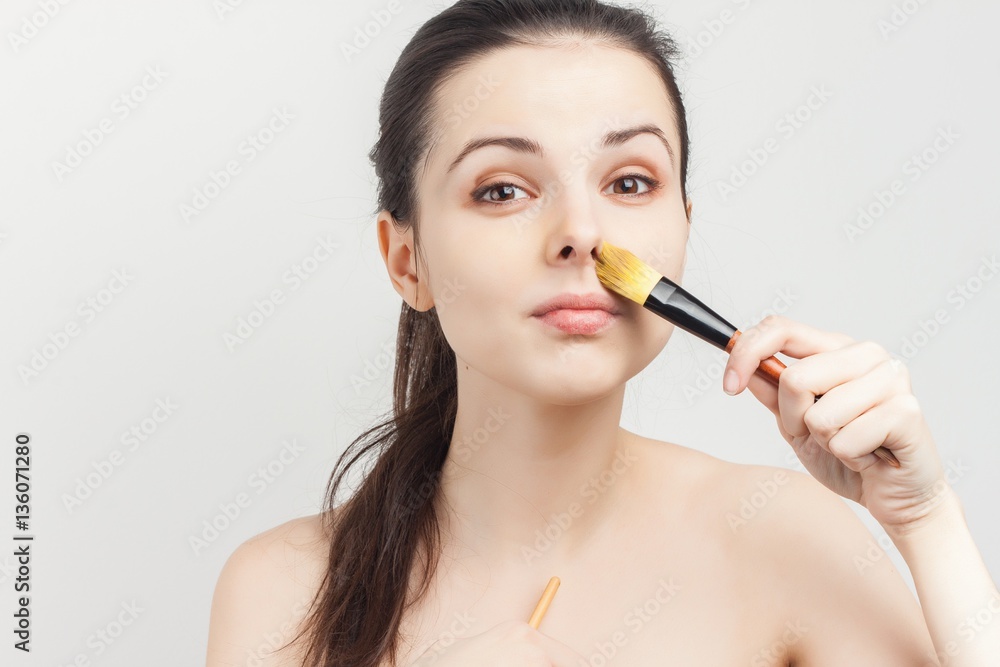 makeup brush in the hand woman, tender skin makeup brush in the hand woman, tender skin