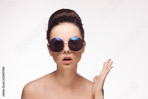 stylish woman in sunglasses on a white background