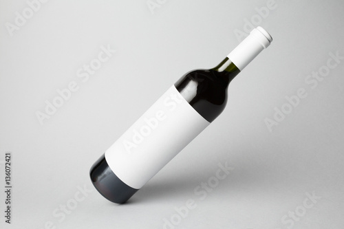 Slanted bottle on gray background