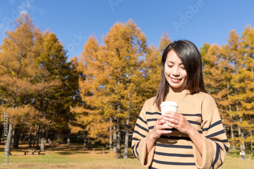 Woman enjoy her coffee with autumn landscape