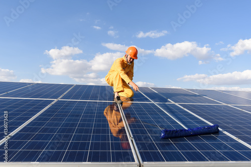 Solar power plant. worker in solar power plant  on a background