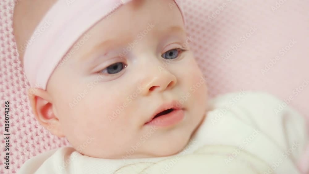 baby girl in white dress and headband and smiling in studio baby girl in white dress and headband and smiling in studio