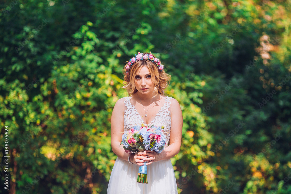 bride with flowers in hand outdoor. Blond woman circle wedding dress. bride with flowers in hand outdoor. Blond woman circle wedding dress.