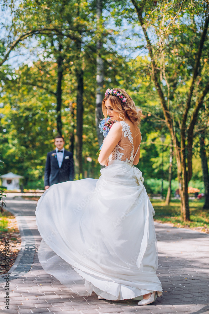 Portrait of kissing newlyweds. Bride and groom in the park. Dancing couple on the nature. Portrait of kissing newlyweds. Bride and groom in the park. Dancing couple on the nature.