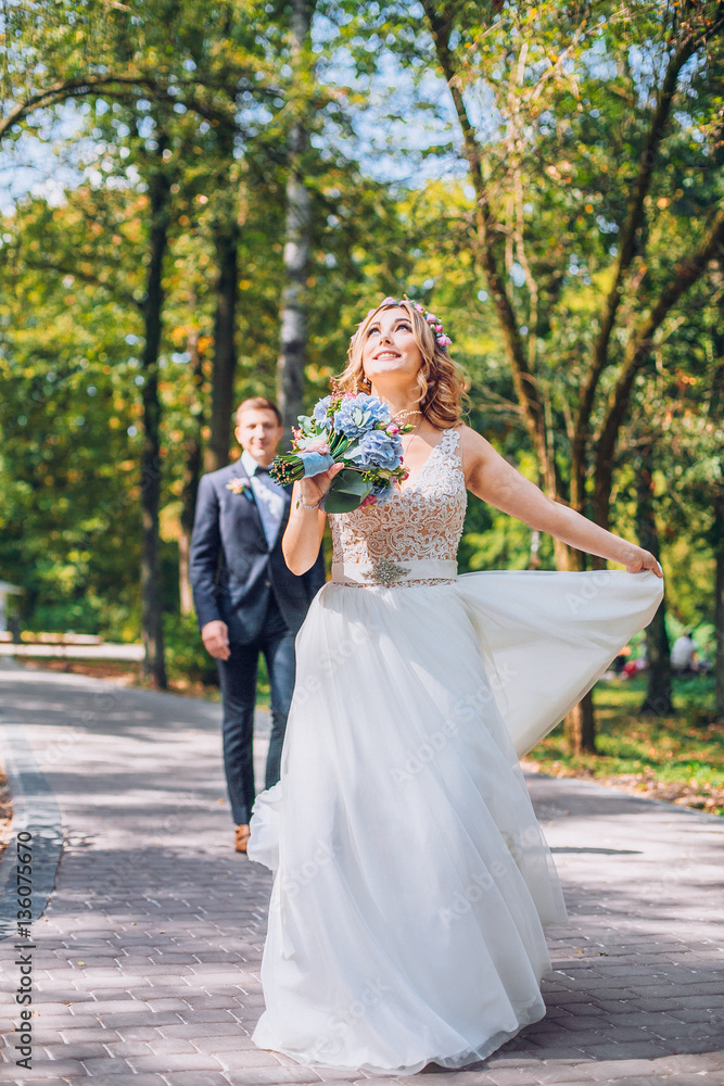 Portrait of kissing newlyweds. Bride and groom in the park. Dancing couple on the nature. Portrait of kissing newlyweds. Bride and groom in the park. Dancing couple on the nature.