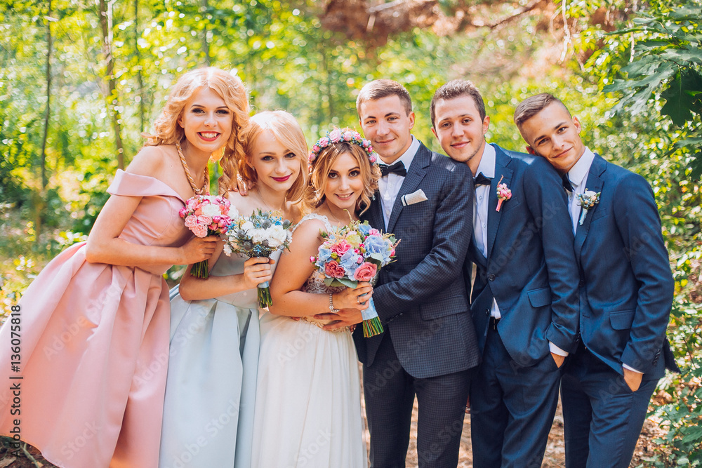 beautiful newlyweds with their friends having fun together. Friendship picture. All time together. Bridesmaids and groomsman with bride and groom.