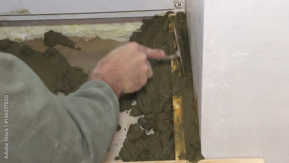 Plasterer builder working with cement and trowel Plasterer builder working with cement and trowel